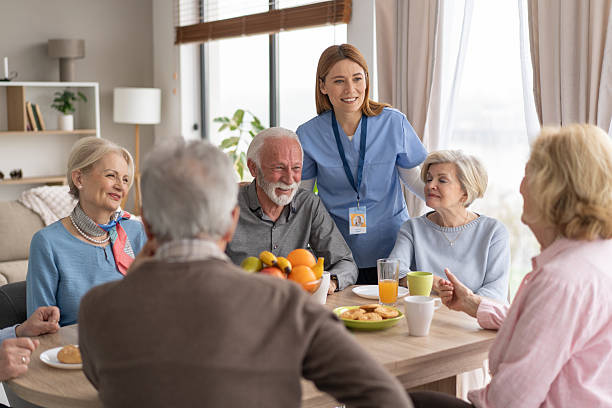 istock Seniors and caregiver sharing joyful moments at dining table 2212586922
