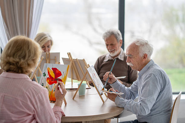 istock Group of seniors enjoying their painting workshop session 2212586964