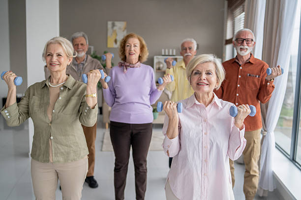 istock Seniors exercising with dumbbells in a group setting 2212587007
