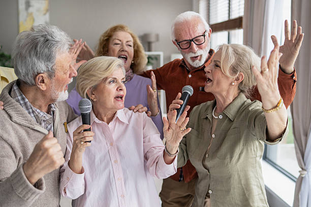 istock Vibrant celebration with elderly friends singing together 2212587015