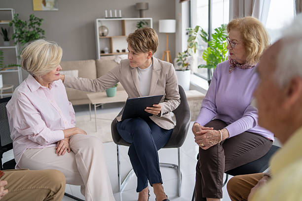 istock Engaging moment between facilitator and seniors in meeting 2212587027