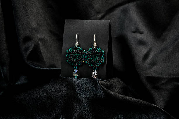 istock Elegant Handmade Beaded Earrings on Black Satin 2212588864