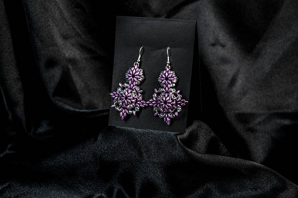 istock Elegant Handmade Purple Beaded Earrings on Black Satin 2212588865