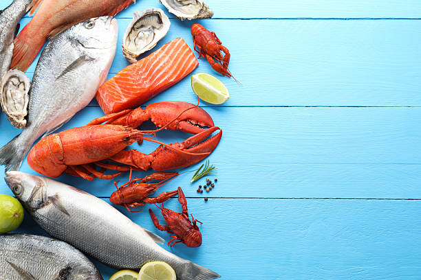 istock Different sea food on light blue wooden table, flat lay. Space for text 2212591062
