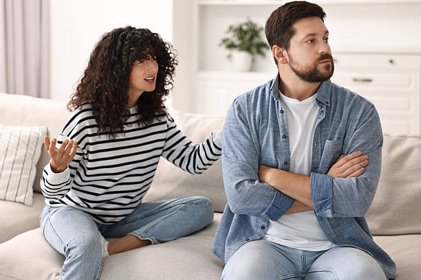 istock Emotional couple arguing on sofa at home. Relationship problems 2212593059
