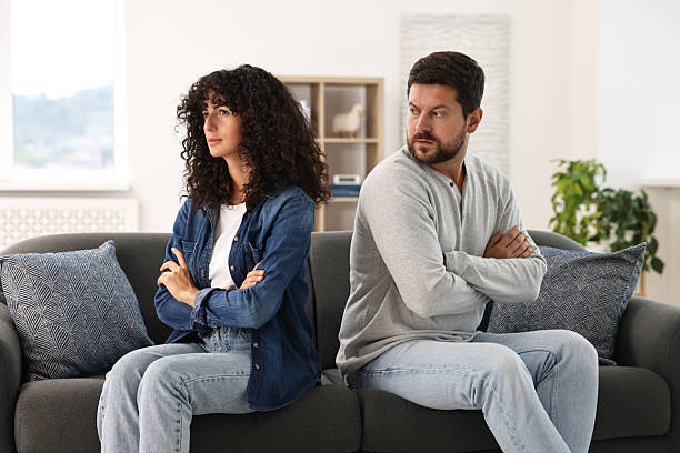 istock Emotional couple having quarrel on sofa at home. Relationship problems 2212593177