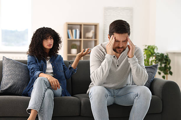 istock Emotional couple having quarrel on sofa at home. Relationship problems 2212593214