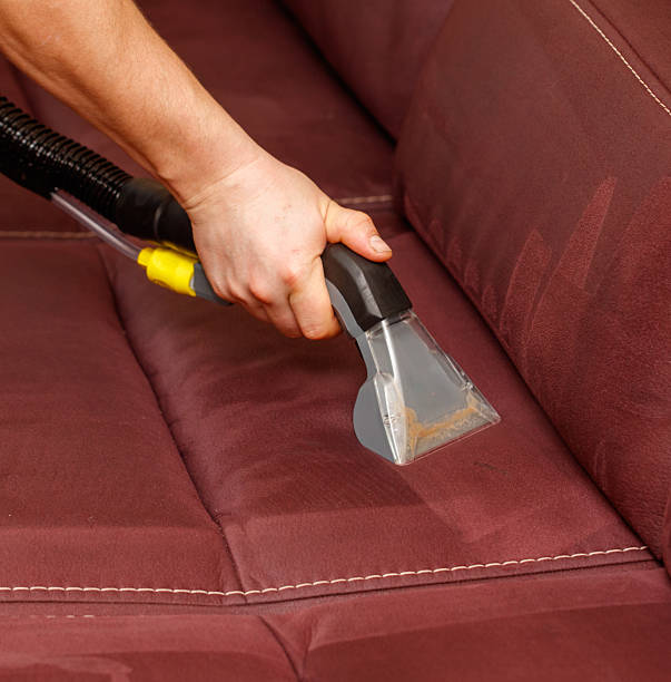 istock A person is cleaning a couch with a steam cleaner 2212593963