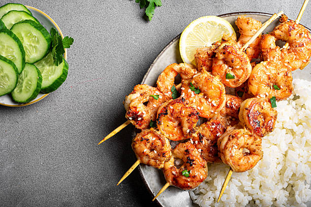 istock Grilled shimp prawn satay skewers with steamed rice 2212594063