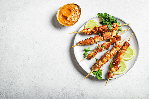 istock Malaysian chicken satay skewers with peanut sauce 2212594319