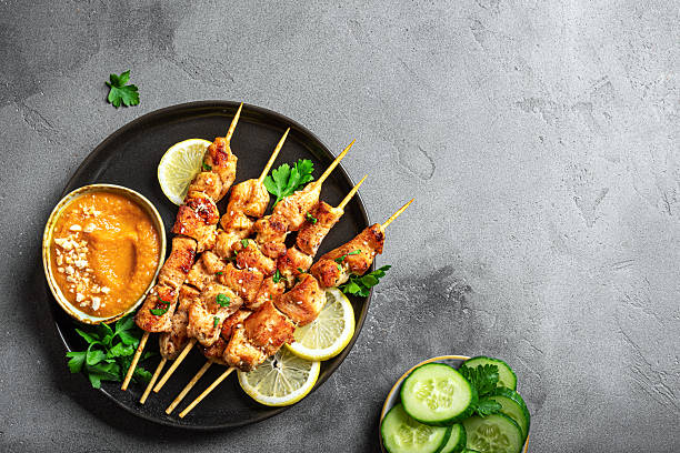 istock Grilled Chicken satay skewers and peanut spicy sauce 2212595021