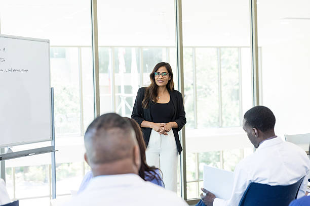 istock Confident businesswoman giving a presentation to a diverse group 2212595097
