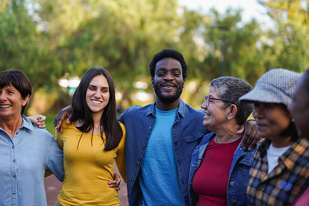 istock Multi generational diverse people hugging each other at city park - Community and social inclusion concept 2212595833