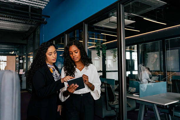 istock Two women talking in the office 2212595952