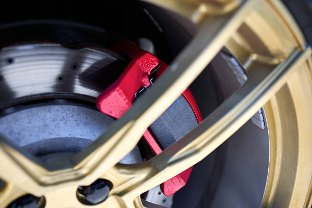 istock Closeup detail red brake callipers and brake discs 2212595965