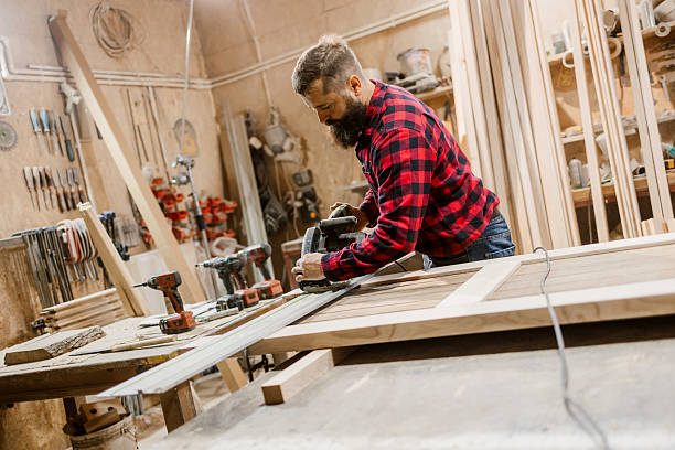 istock Skilled craftsman working in a woodworking shop on a project using a power tool 2212596947