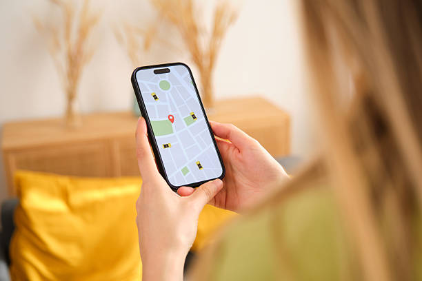 istock Woman using rideshare app on smartphone at home 2212599602