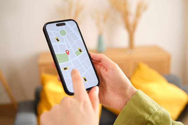 istock Woman Ordering Taxi Using Mobile App at Home 2212599646