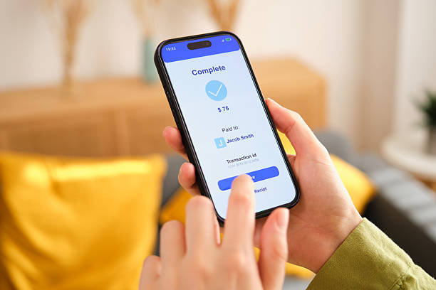 istock Woman using smartphone for online payment at home 2212600358