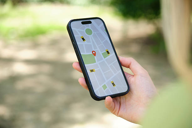 Woman holding smartphone displaying ride hailing app with map and available taxis