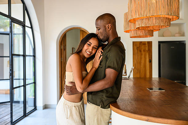 istock Cozy couple sharing an affectionate moment in a modern and stylish kitchen space 2212601440