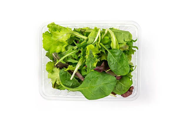 istock Fresh vegetarian salad - arugula, spinach, red spinach, lettuce isolated on white background. Image of different useful leaves in a plastic tray on white 2212601495