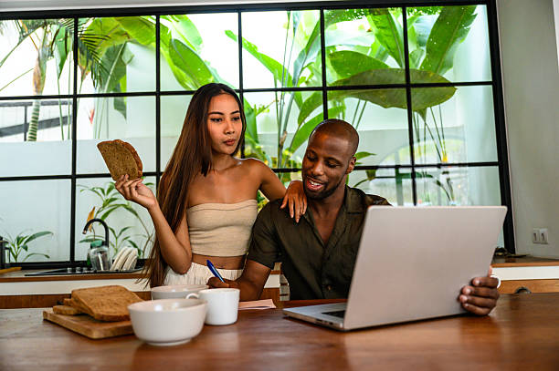 istock Couple enjoying breakfast and working together in a modern open kitchen setting 2212601610