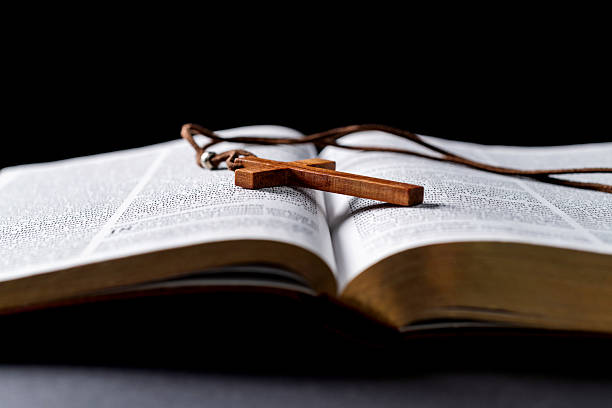 istock Wooden cross and bible on the table 2212602187