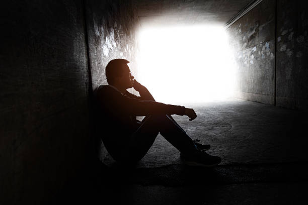 istock One man sitting in the dark tunnel 2212602291