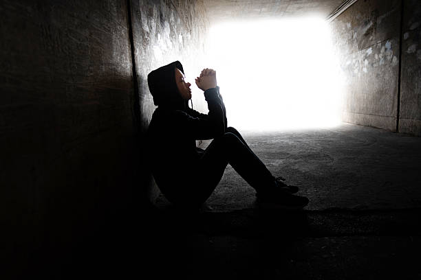 One man sitting in the dark tunnel.