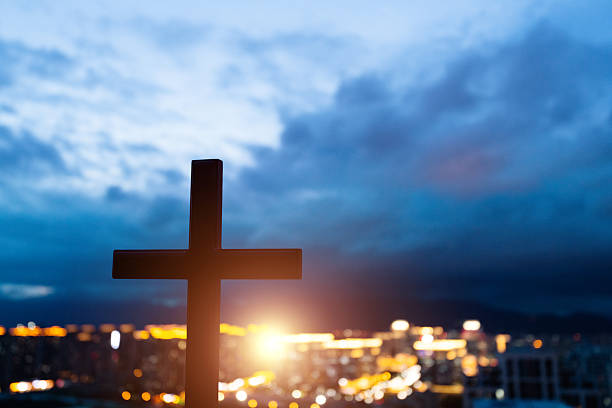 Religious cross on city background.