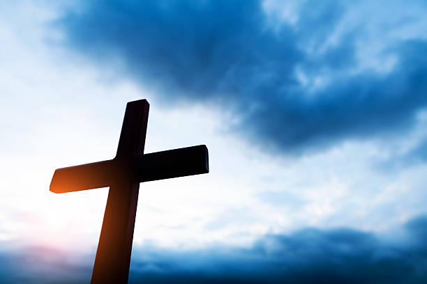Silhouette of the cross with rays of light.