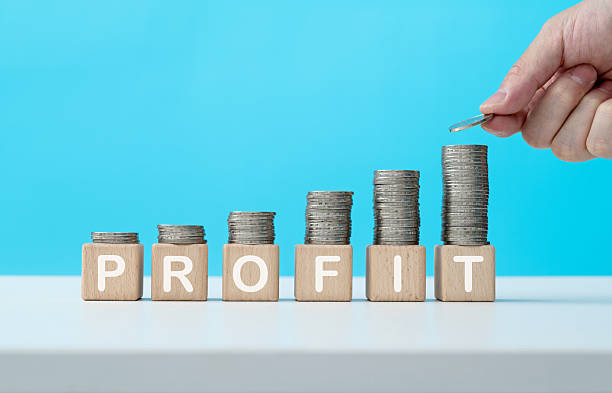 istock Stack of coins on word profit 2212603246