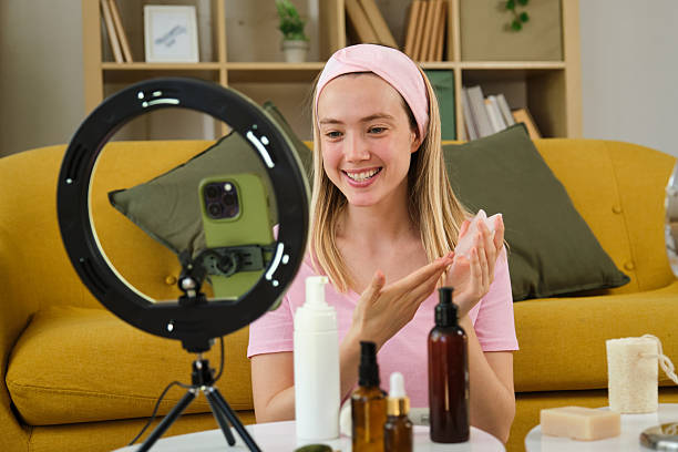 istock Influencer creating beauty video blog promoting cosmetics using smartphone and led ring light 2212603453