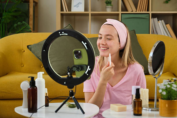 istock Influencer using gua sha stone and recording video for social media with led ring light and phone 2212603695