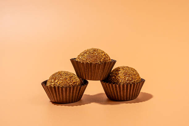 istock Three brown cupcakes stacked on top of each other 2212603871