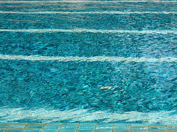 istock Swimming pool with crystal clear green water. 2212604646