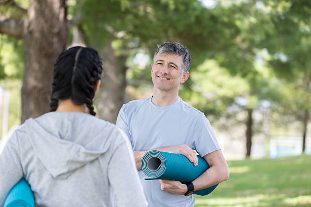 istock Active 40s Couple Talking Before Yoga in the Park 2212608386