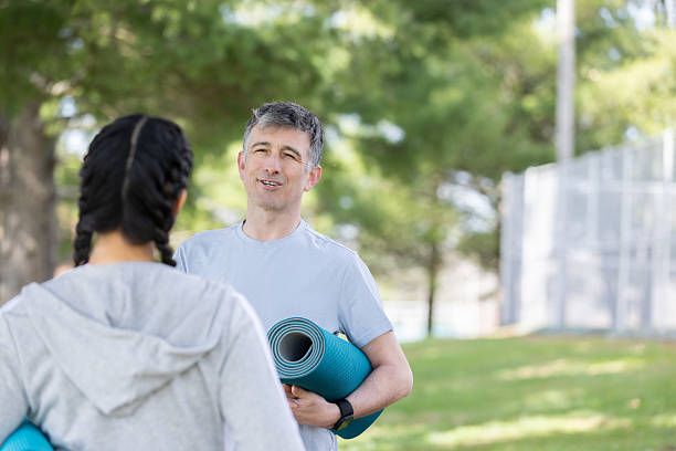 istock Relaxed Married Couple Sharing Time Before Group Yoga 2212608391