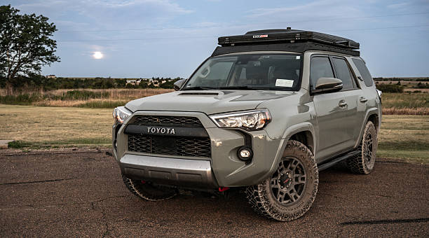 Kansas, United States: June 22, 2024: Toyota 4Runner With Rooftop Tent Sits Below Full Moon In Kansas State Park