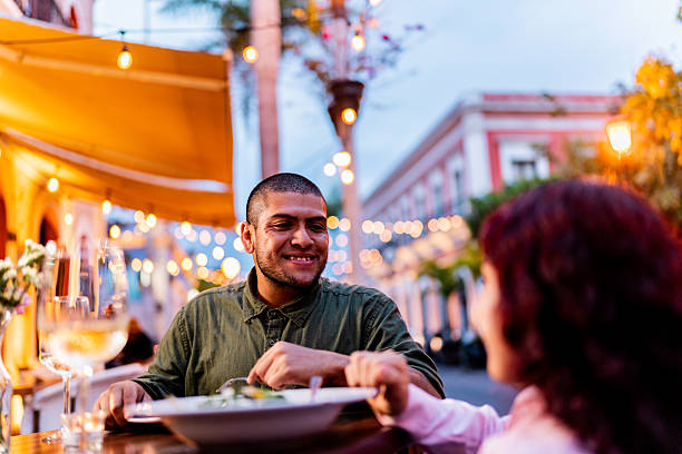 istock Young wheelchair couple talking during dinner at restaurant 2212609516