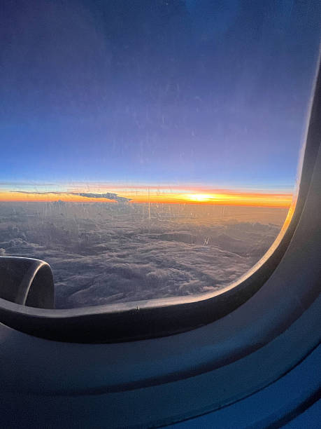 istock Sunset from airplane - plane window seat view 2212616555