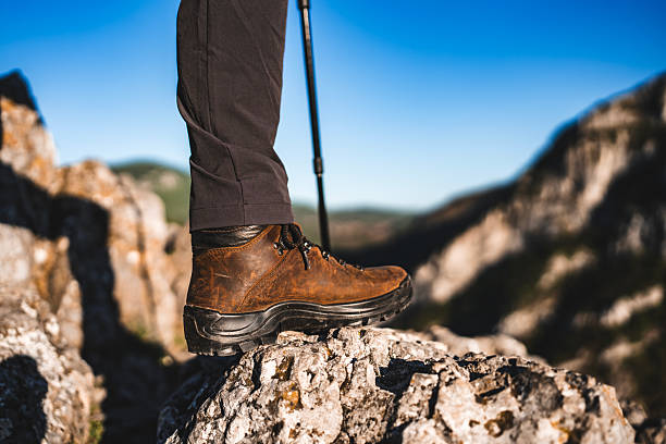 istock Hiker's Boot on Rocky Path with Scenic Mountain Background 2212617204