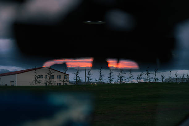Sunset in rear view mirror during road trip in Iceland