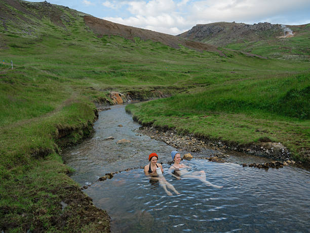Two women talking in hot spring during experiential trip Iceland