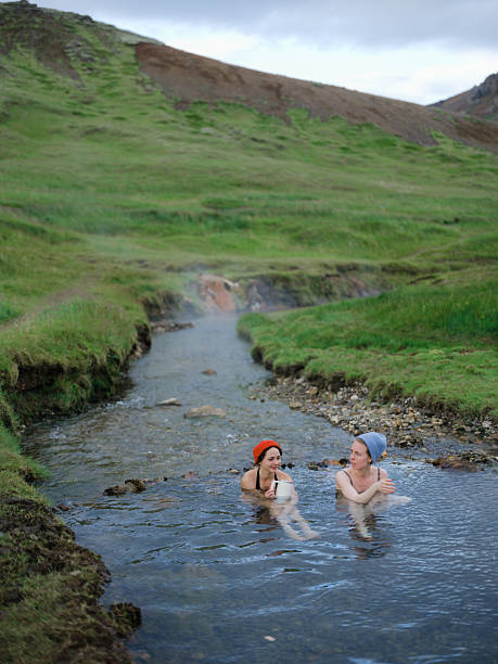 Two women talking in hot spring during experiential trip Iceland
