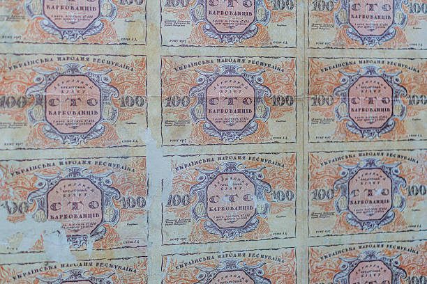 istock Historical, aged Ukrainian banknote pasted on a surface Features a portrait and intricate patterns in blues, greens, purples, and yellows Shows both left and right sides with 3D effect under natura 2212621725