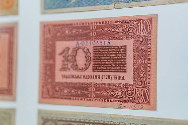 istock Historical, aged Ukrainian banknote pasted on a surface Features a portrait and intricate patterns in blues, greens, purples, and yellows Shows both left and right sides with 3D effect under natura 2212621894