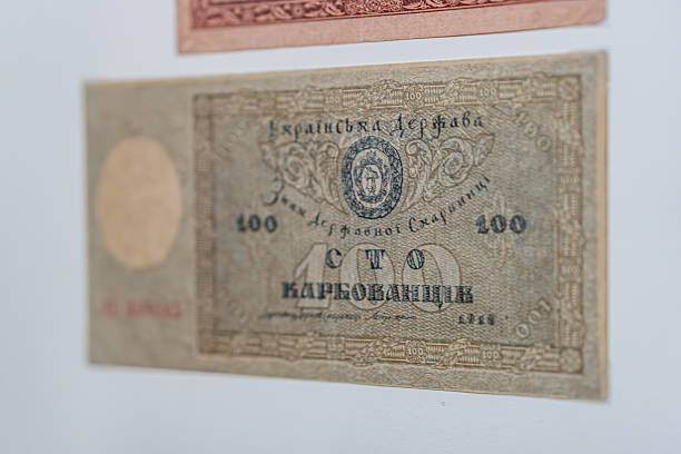 istock Historical, aged Ukrainian banknote pasted on a surface Features a portrait and intricate patterns in blues, greens, purples, and yellows Shows both left and right sides with 3D effect under natura 2212621965