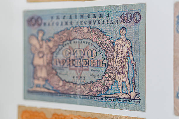 istock Historical, aged Ukrainian banknote pasted on a surface Features a portrait and intricate patterns in blues, greens, purples, and yellows Shows both left and right sides with 3D effect under natura 2212622054